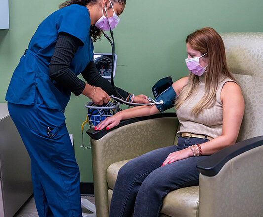 A Swift Health Morrow team member helping a patient