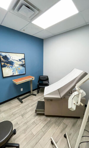 A modern, comfortable-looking room with medical equipment and artwork used for patient care at Swift Health Morrow