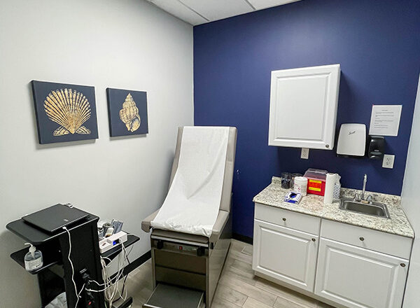A photo of a Swift Health Morrow interior room with medical equipment and artworks on the walls