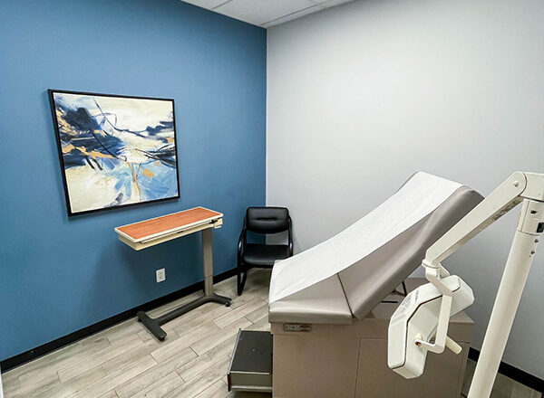 A modern, comfortable-looking room with medical equipment and artwork used for patient care at Swift Health Morrow