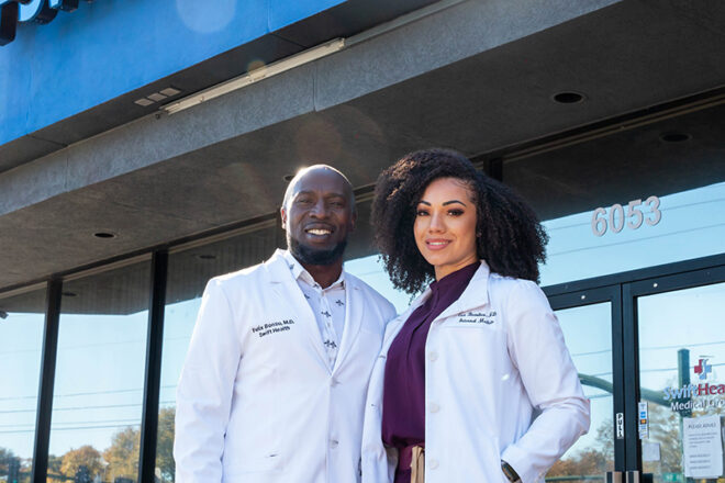 Two Swift Health Morrow doctors standing together in front of the clinic's front door