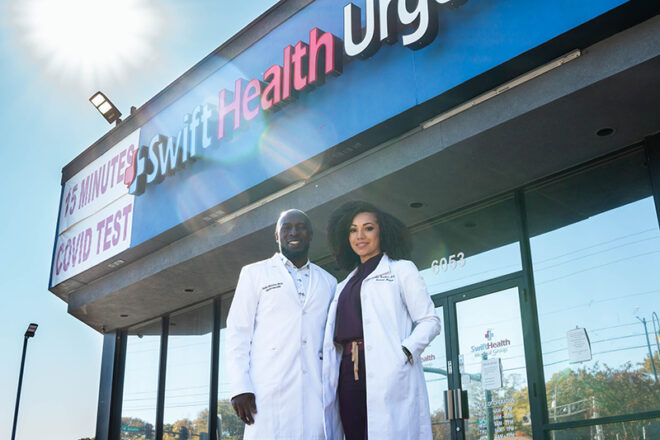 Two doctors at Swift Health Morrow smiling together in front of the clinic